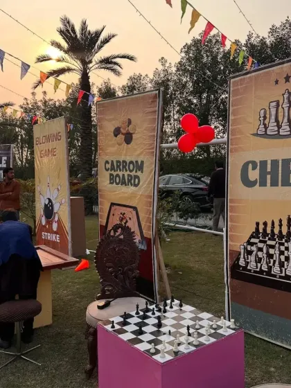 As the sun sets, the game night continues. This shot shows the oversized chess and carrom board stations, which were a huge hit with guests.