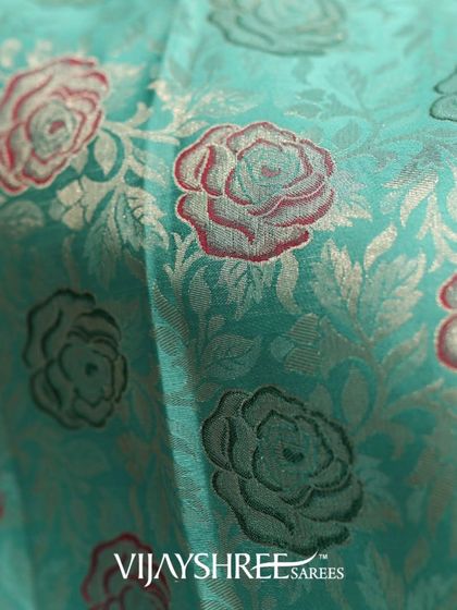 A detailed close-up of the woven rose motifs, showcasing the intricate color work achieved on the handloom.