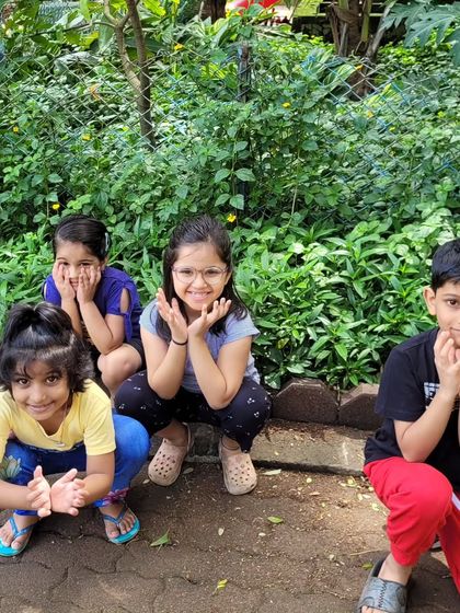 A moment of fun and play during our outdoor kids' yoga session. Smiles and laughter are just as important as the poses themselves in my classes.