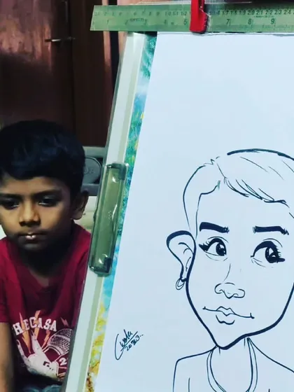 A quiet moment of concentration. This young boy is watching intently as I create his portrait right next to him.