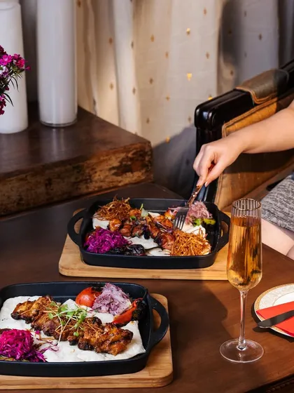 Enjoy a luxurious indulgence with our Turkish chicken wings, perfectly paired with a glass of champagne. It's a culinary voyage where every bite leaves you craving more.