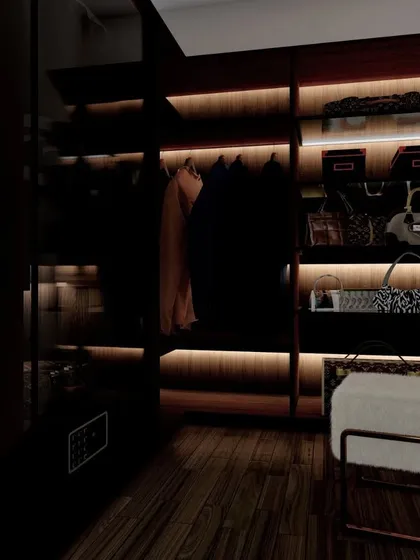 A duplicate of 95, showing a luxurious walk-in closet design with dark wood and integrated backlighting, perfect for organizing clothes and accessories.