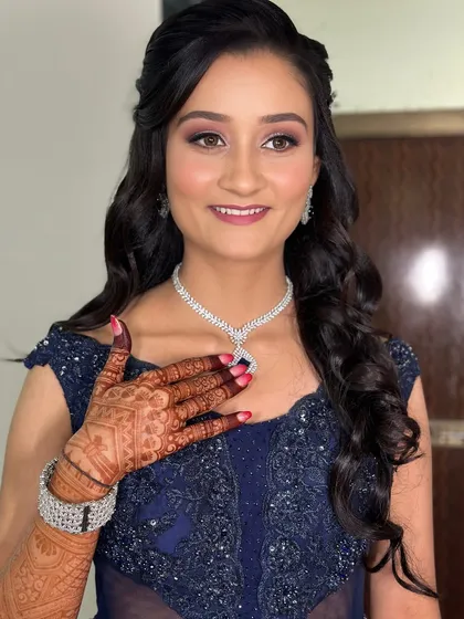 The bride's happiness shines through, loving her glamorous party look.