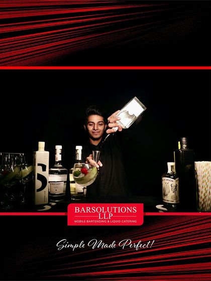 A flair bartender adding a garnish to a gin and tonic at the fashion show, combining skill with a touch of performance.