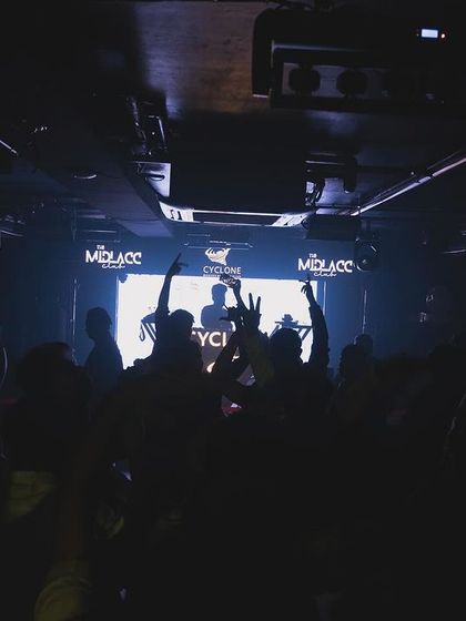 A darker shot of the crowd at Cyclone, lost in the music.