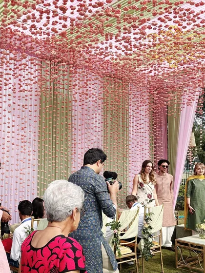 Guests taking photos and enjoying the beautiful pastel-themed ambiance.