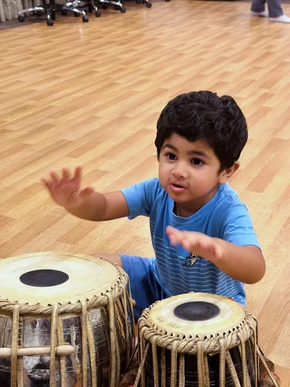 This is where the magic begins. We believe in a hands-on approach, letting even our youngest students feel the rhythm and connect with real Indian classical instruments like the tabla. It’s about sparking curiosity and building a love for music from the very first beat.
