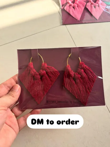 A pair of my diamond-shaped macrame tassel earrings in a beautiful deep red color, all packed up and ready to go.