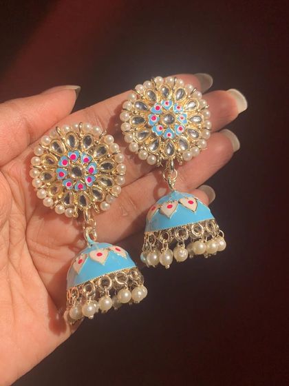 These sky-blue Meenakari jhumkas with Kundan and pearl work are absolutely breathtaking. They are perfect for a summer wedding or festive event.