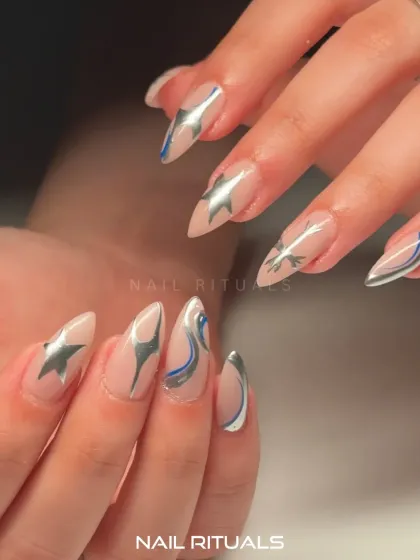 Another angle of our galactic-inspired nails. The combination of silver, blue, and nude creates a modern and stunning look.