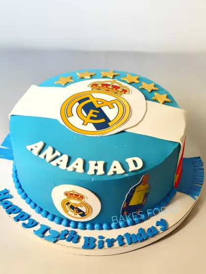 A Real Madrid football club-themed cake, featuring the team's logo and colors. A great choice for a dedicated fan's birthday.