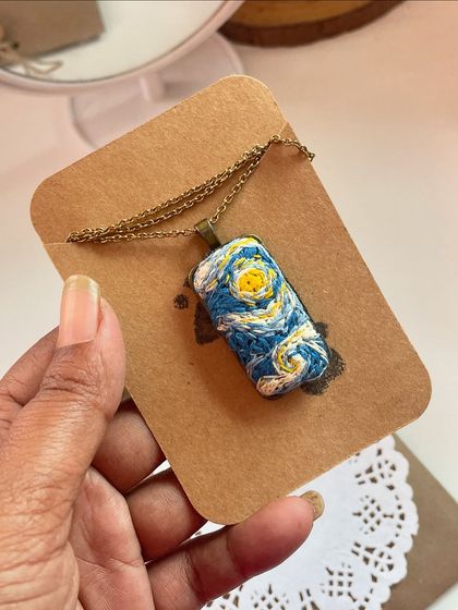 For the art lover, I created this hand-embroidered "Starry Night" pendant. It's a tiny, wearable piece of art that captures the magic of Van Gogh's famous painting.
