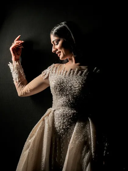 A dramatic portrait of the bride, ready for her reception. We direct these moments with photographers to capture the glamour and emotion of the evening.