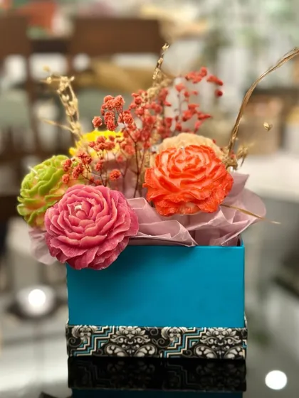 A bouquet that never wilts! This is one of my favorite custom gifts to make, featuring a collection of hand-carved rose candles in vibrant colors, arranged with dried flowers in a lovely gift box.