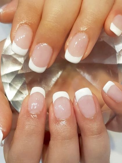 A classic French manicure on short, square-shaped nails. This look is clean, timeless, and perfect for any occasion.