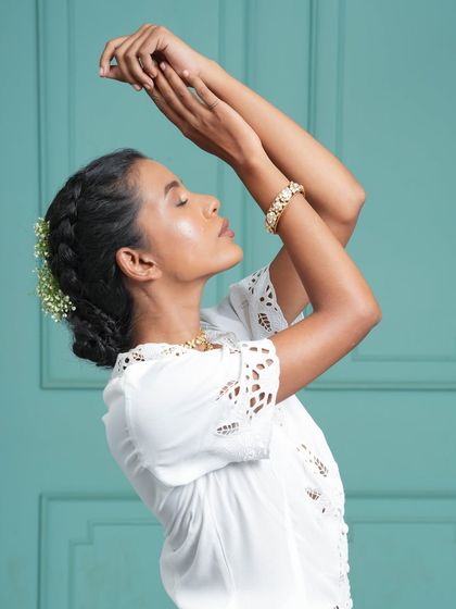 Another beautiful bridal hairstyle inspiration. The extensions are seamlessly woven into a bun, decorated with delicate flowers for a soft, romantic look.
