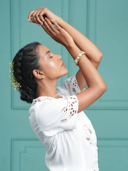 An elegant and graceful bridal updo, decorated with delicate baby's breath flowers. Our extensions help create the full, structured bun that is essential for such classic hairstyles.