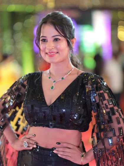 A close-up of Anusha Rai's stylish black top with dramatic, sequined sleeves.