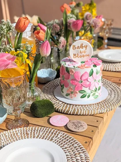 I love seeing my cakes as part of a beautiful celebration. This "Baby in Bloom" floral cake was the star of a gorgeous baby shower, and this photo captures the joy of the moment perfectly. The bright pink flowers on the cake matched the fresh tulips on the table.
