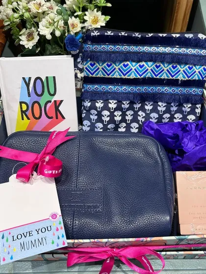 A curated gift box for Mummy, filled with beautiful pouches, a notebook, and perfume.