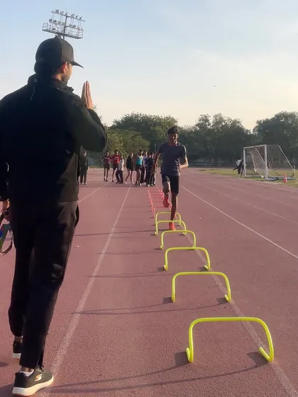 A high-five for a well-executed drill. I believe in positive reinforcement to keep my athletes motivated and confident as they tackle challenging agility workouts.