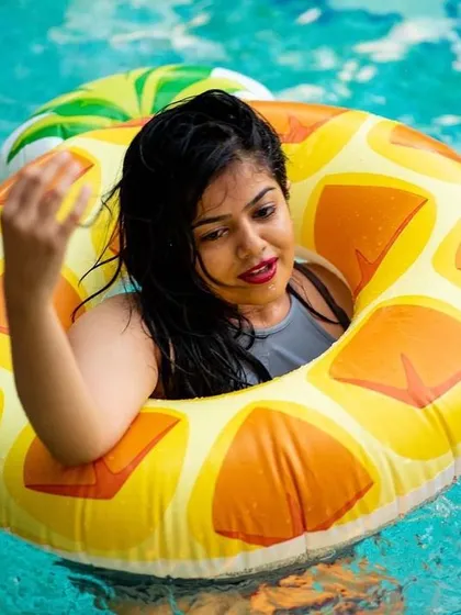 A guest floating on a pineapple pool float. It's all about fun and summer vibes.