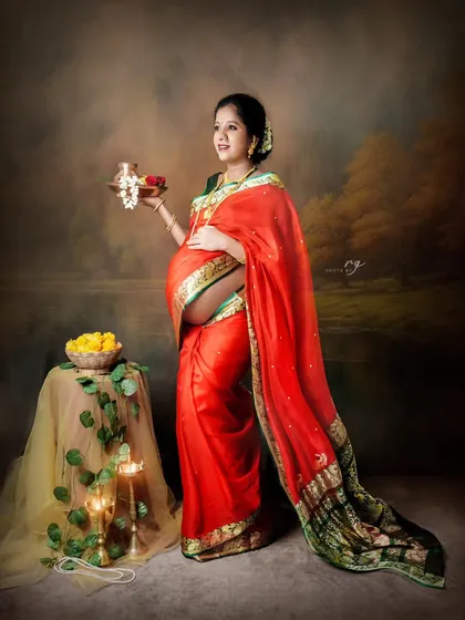 Dressed in a traditional saree and holding a platter of offerings, the mom-to-be looks like a goddess. We use painted backdrops and props to create a complete, immersive scene.