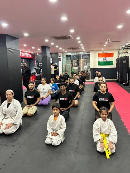 Students of all ages, from kids to adults, kneel in a traditional seiza position. This shows the discipline and respect that is central to our martial arts philosophy.