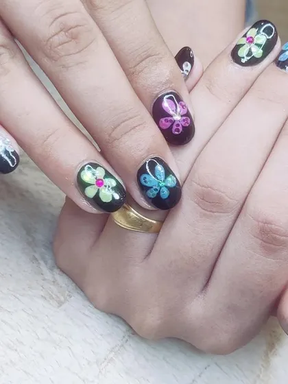 Colorful neon flowers on a black base make for a striking contrast. This design is bold, fun, and shows off intricate detail work.