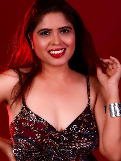 A bright and happy portrait with a beautiful smile. The red background makes her joy feel even more vibrant.