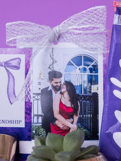 A personalized polaroid-style photo of the couple, adorned with a delicate ribbon, serves as a beautiful centerpiece for this bridal hamper.