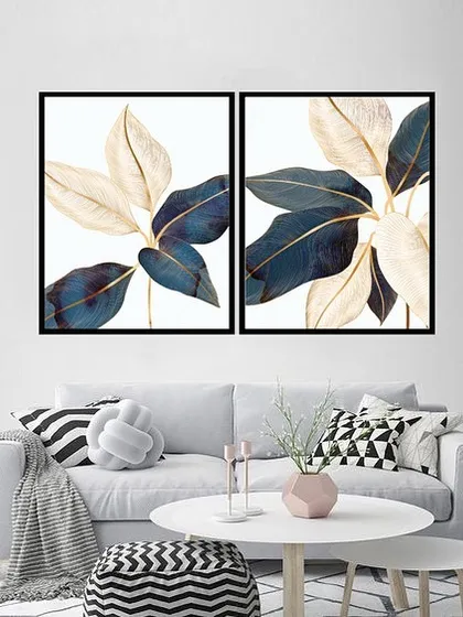 A beautiful set of two framed prints featuring sleek banana leaves in shades of deep blue and cream. The elegant, flowing lines and sophisticated color palette add a touch of luxury to any room.