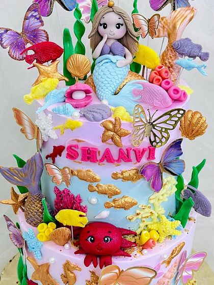 Close-up of the intricate details on the mermaid and butterfly cake.