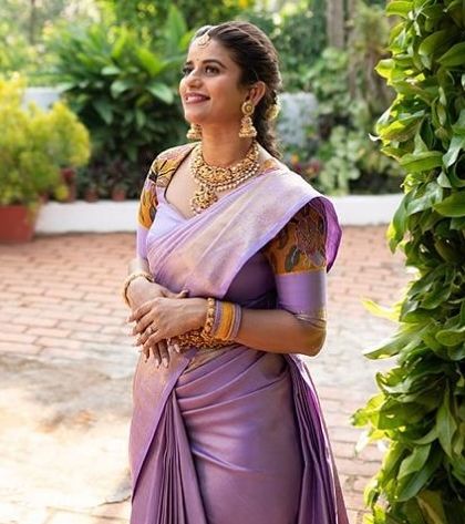 This client looks radiant in a lavender Kanchivaram saree. The blouse features unique printed sleeves, a modern twist that I incorporated into her custom design.
