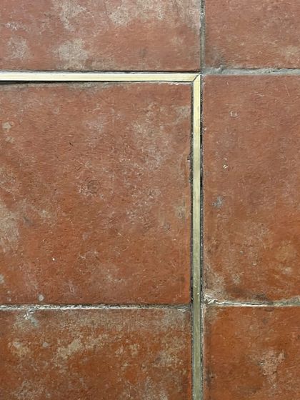 The flooring at Eka features a subtle brass inlay within the terracotta tiles. This detail adds a touch of refinement and quietly guides the customer's journey through the space, reflecting our focus on small, meaningful design gestures.