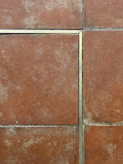 The flooring at Eka features a subtle brass inlay within the terracotta tiles. This detail adds a touch of refinement and quietly guides the customer's journey through the space, reflecting our focus on small, meaningful design gestures.