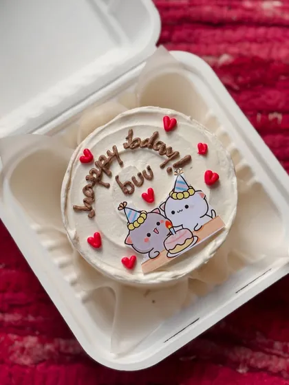 An adorable bento cake featuring a cute cartoon of two cats celebrating a birthday. I can add these edible printed toppers to any cake.