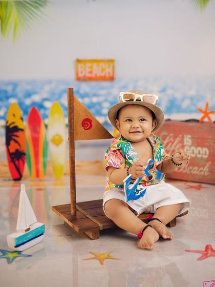 A cool and casual pose from the little surfer, with his sunglasses perched on his hat. This shot is full of personality.