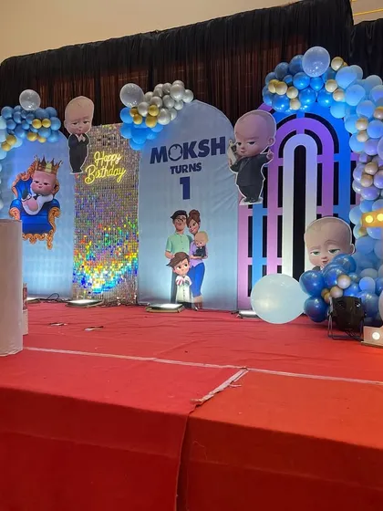 A side view of the grand Boss Baby setup, highlighting the layered backdrops and the large light-up number '1'.