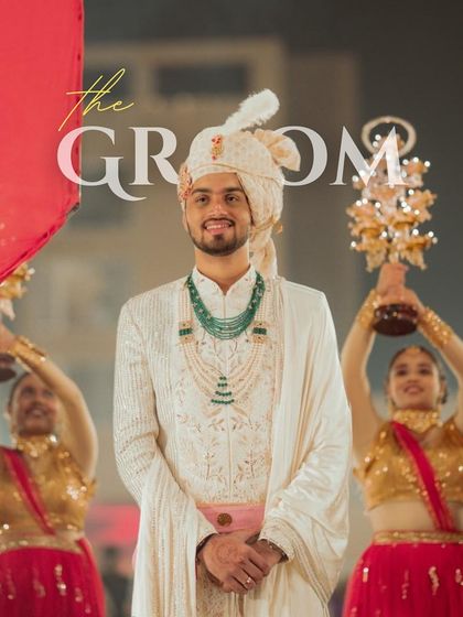 A regal groom entry, flanked by performers, creating a royal and grand welcome.