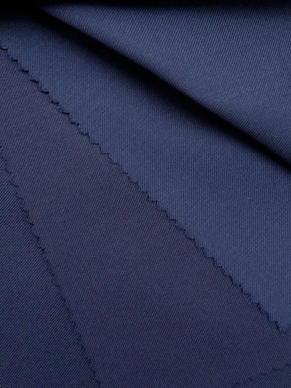 The rich texture and color of our navy wool fabric. This is a perfect choice for a classic blazer or a full suit that exudes authority and style.