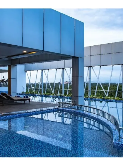 The rooftop swimming pool at a luxury hotel in Calicut, Kerala. The design offers guests a serene escape with expansive views, showcasing our ability to create premium leisure amenities.