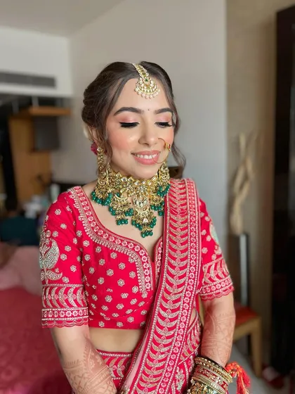 A beautiful close-up of Akshita's bridal makeup, with her eyes closed to showcase the delicate and blended eyeshadow work.