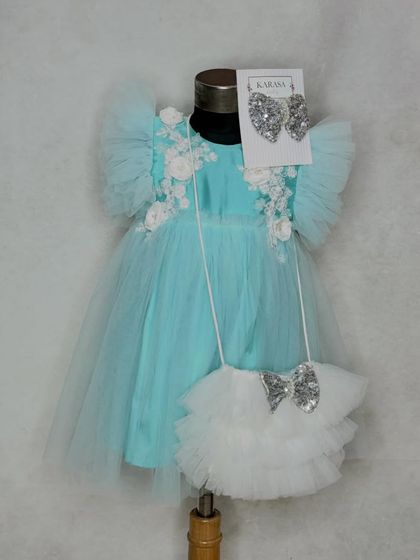 The perfect gift for a loved one's first birthday. Our "Alia" dress in aqua comes with a matching ruffled bag and sequin bow, all beautifully packed in our gift box.