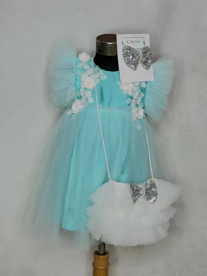 The perfect gift for a loved one's first birthday. Our "Alia" dress in aqua comes with a matching ruffled bag and sequin bow, all beautifully packed in our gift box.