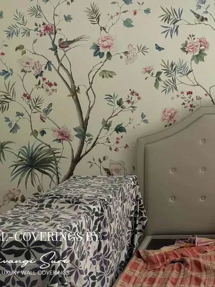 A bedroom wall becomes a canvas for a custom Chinoiserie mural. The artful placement of flowering trees and birds creates a tranquil and opulent atmosphere, setting the stage for true relaxation.