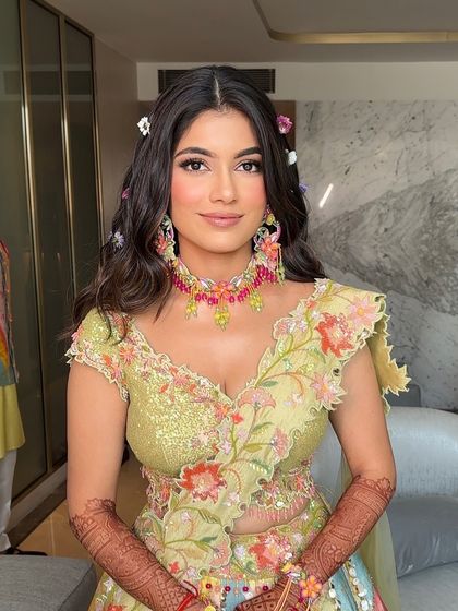 A fresh and romantic look for a Mehendi, with soft open waves and tiny flowers scattered throughout the hair.