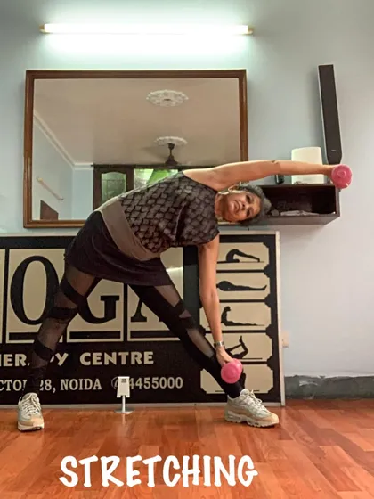 Another view of the standing side bend with weights, a great way to tone the obliques while stretching the side body.