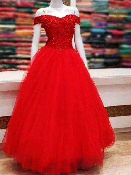 A timeless red ball gown with an off-shoulder, sparkling beaded bodice. This is a classic choice for anyone wanting to feel like a princess for their pre-wedding shoot or party.