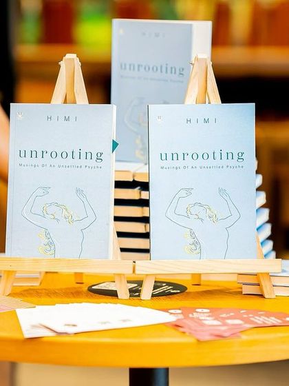 The book "Unrooting" displayed on mini easels, a small but thoughtful detail we manage to make your book the star of the show.